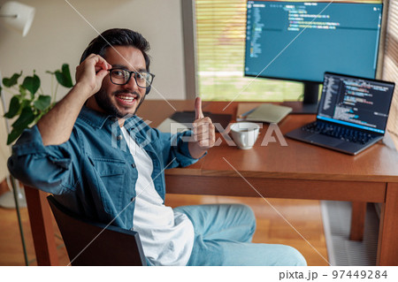 Male freelancer making new project as web designer or programmer on his computer at home office 97449284