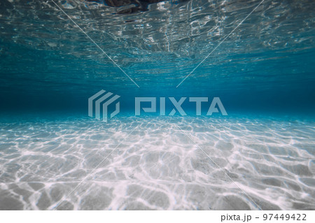 Blue ocean with white sand and sunlight underwater. Transparent ocean background 97449422