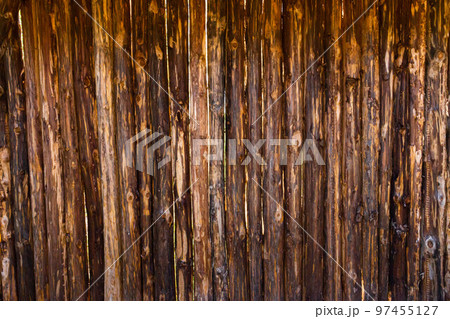 vertical texture of thin rough-hewn trees next to each other vertical texture of thin rough-hewn trees next to each other 97455127