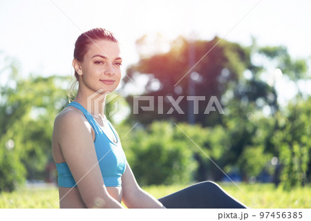 Beautiful smiling girl in sportswear relax in park Beautiful smiling girl in sportswear relax in park 97456385