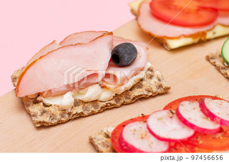 Whole Grain Crispbread with Ham, Tomato, Radish, Cucumber and Cheese 97456656