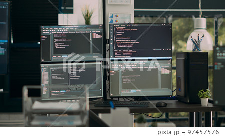 Empty office desk with multiple screens running software developing script on terminal window, it agency computers showing code database algorithms, network servers innovation. Empty office desk with multiple screens running software developing script on terminal window, it agency computers showing code database algorithms, network servers innovation. 97457576