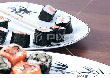 sushi rolls and chopsticks on a wooden table sushi rolls and chopsticks on a wooden table 97459038