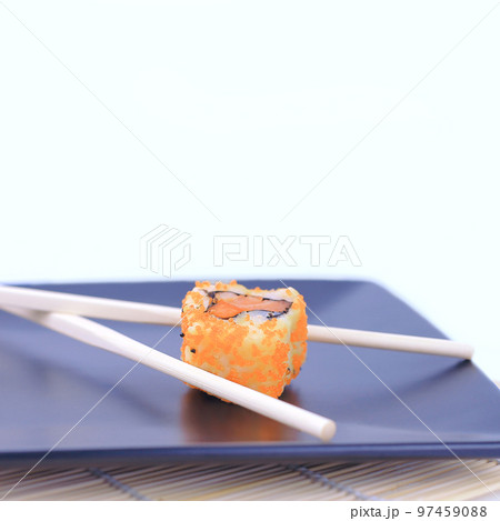 close-up of sushi and chopsticks on a black plate 97459088