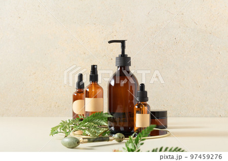 Amber glass bottles on beige background. Soap liquid, shampoo or shower gel, serum, essential oils, anti-age products packaging design 97459276