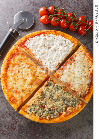 Sliced hot pizza four cheeses close-up on a wooden board. Vertical top view Sliced hot pizza four cheeses close-up on a wooden board. Vertical top view 97463350