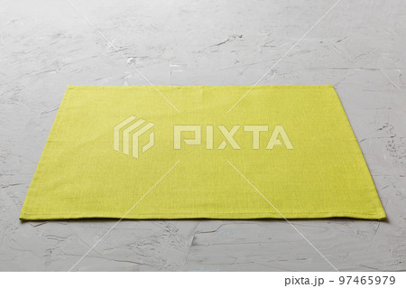 Perspective view of green tablecloth for food on cement background. Empty space for your design 97465979