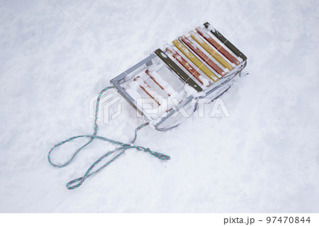 Old sled with a rope on the snow top view. Old sled with a rope on the snow top view. 97470844