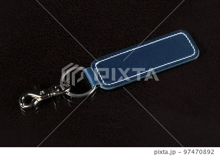 Leather keychain on a dark background. 97470892