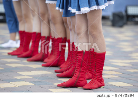 Lots of female legs in red dancing boots. Dance shoes. Lots of female legs in red dancing boots. Dance shoes. 97470894