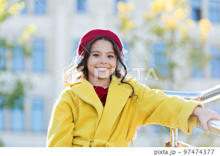 Good vibes only. Awesome sound. Girl kid with headphones urban background. Stereo sound. Child girl autumn outfit enjoying music. Little girl listening music enjoy favorite song excellent sound 97474377
