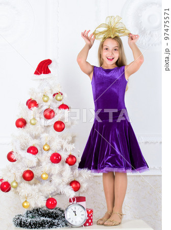Very special time of year. Kid happy because holiday season arrive. Family holiday concept. Girl velvet dress feel festive near christmas tree. Make this day best holiday ever. Winter holiday concept 97475571
