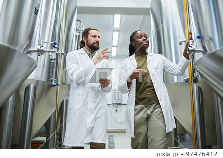 Brewery Workers Checking Equipment 97476412