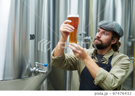 Brewer Checking Quality of Drink 97476432