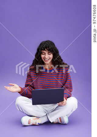 Happy girl with dark long wavy hair communicating in video chat Happy girl with dark long wavy hair communicating in video chat 97476608