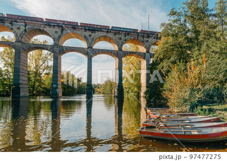 Railway Bridge with river in Bietigheim-Bissingen, Germany. Autumn. Railway viaduct over the Enz River, built in 1853 by Karl von Etzel on a sunny summer day. Bietigheim-Bissingen, Germany. Old Railway Bridge with river in Bietigheim-Bissingen, Germany. Autumn. Railway viaduct over the Enz River, built in 1853 by Karl von Etzel on a sunny summer day. Bietigheim-Bissingen, Germany. Old 97477275