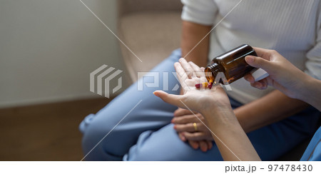 Healthcare worker or caregiver visiting senior woman indoors at home, explaining medicine dosage. Close up shot Healthcare worker or caregiver visiting senior woman indoors at home, explaining medicine dosage. Close up shot 97478430