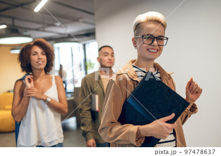 Team of company employees in the office corridor 97478637