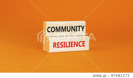 Community resilience symbol. Concept word Community resilience typed on wooden blocks. Beautiful orange table orange background. Business and community resilience concept. Copy space. 97482272