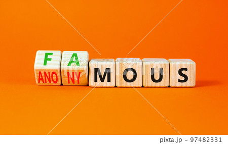 Famous or anonymous symbol. Concept word Famous and Anonymous on wooden cubes. Beautiful orange table orange background. Business famous or anonymous concept. Copy space. Famous or anonymous symbol. Concept word Famous and Anonymous on wooden cubes. Beautiful orange table orange background. Business famous or anonymous concept. Copy space. 97482331
