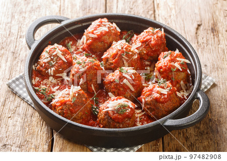 Polpette meatballs with parmesan stewed in a rich tomato sauce close-up in a frying pan. Horizontal 97482908