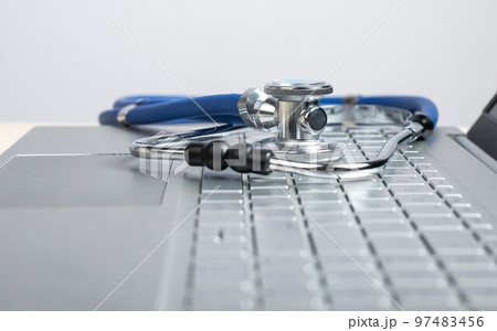 Stethoscope on laptop. Telemedicine, telehealth concept. Online video diagnostics. Using electronic communications and software for treatment. 97483456