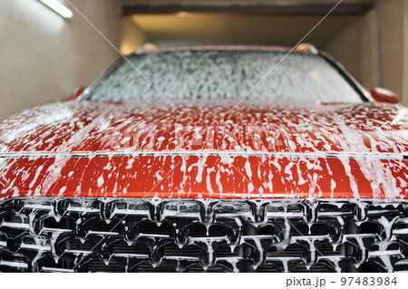 Close up photo of car hood in indoors car washing service. 97483984