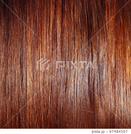 Hair texture close up chestnut golden brown color, closeup view of bunch of reddish auburn straight brown hair smooth shiny 97484507