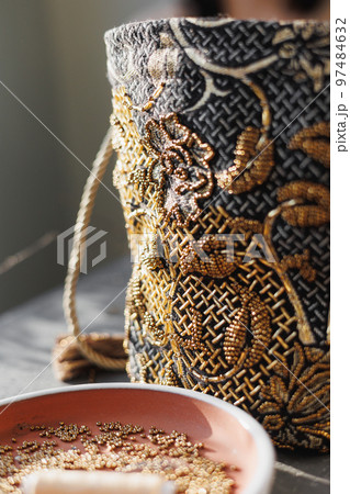 bag of precious stones sits on table, soft selective focus. bead embroidery, hobby design bag of precious stones sits on table, soft selective focus. bead embroidery, hobby design 97484632