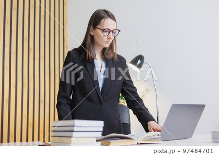 business woman is working on laptop in office, job with papers. confident business lady 97484701