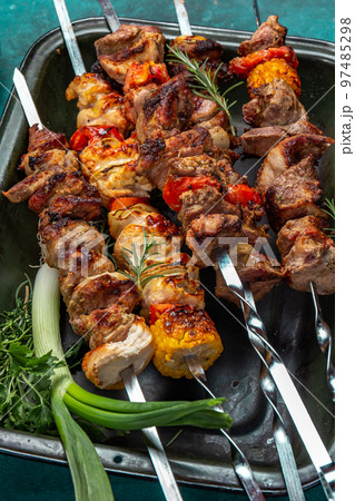 Bbq grilled meat pork, chicken and vegetable skewers on tray. Top view, flat lay Bbq grilled meat pork, chicken and vegetable skewers on tray. Top view, flat lay 97485298