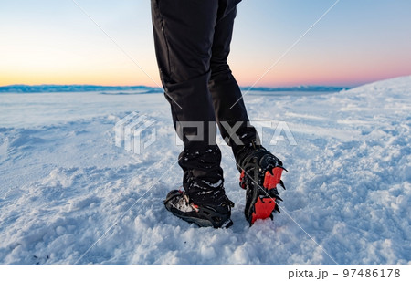 Mountain Boot with crampons on while hiking in the mountains in winter. 97486178