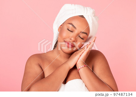 Beauty sleep concept. Portrait of black body positive lady napping, pretending sleeping over pink studio background 97487134