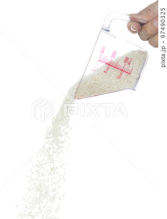 Japanese Rice fall, white grain rices pouring down abstract cloud fly from measuring Cup. Beautiful complete seed rice in air, food object design. Selective focus freeze shot white background isolated 97490325