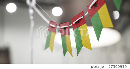 A garland of Guinea Bissau national flags on an abstract blurred background A garland of Guinea Bissau national flags on an abstract blurred background 97500930