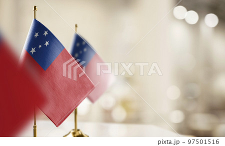 Small flags of the Samoa on an abstract blurry background 97501516