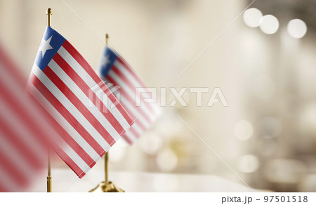 Small flags of the Liberia on an abstract blurry background 97501518