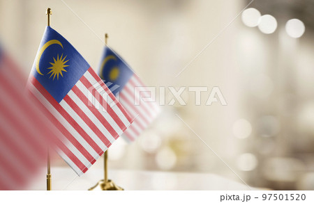 Small flags of the Malaysia on an abstract blurry background 97501520