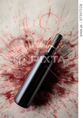 Bottle of red wine on a background with stains of wine. 97507528