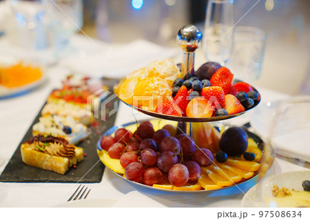 snacks and and a plate and fruit platter on the table. catering  97508634