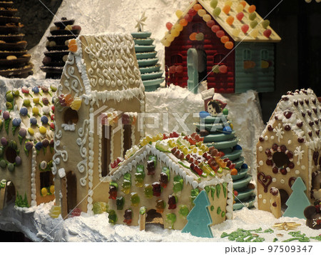 Christmas Gingerbread and chocolate House decorated with candy canes, marshmallow cones gummy bears Christmas Gingerbread and chocolate House decorated with candy canes, marshmallow cones gummy bears 97509347
