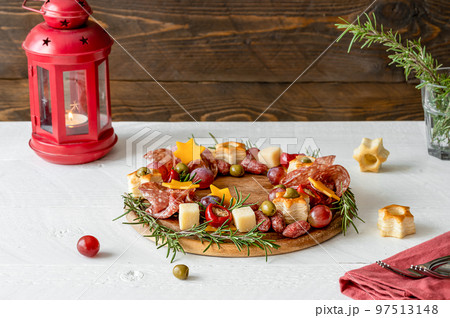 Christmas appetizers wreath with rustic wooden background, star of Christmas plant or Poinsettia, rosemary, lantern Christmas appetizers wreath with rustic wooden background, star of Christmas plant or Poinsettia, rosemary, lantern 97513148