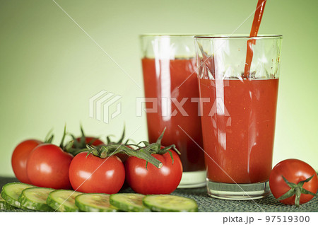 Tomato juice from fresh tomatoes with cucumbers. Healthy food. Vegetarian drink. Tomato juice from fresh tomatoes with cucumbers. Healthy food. Vegetarian drink. 97519300