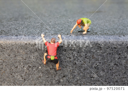 a mini figure Hikers climbing on mountain. 97520071