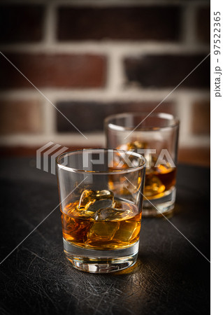 Whiskey with ice in glasses 97522365