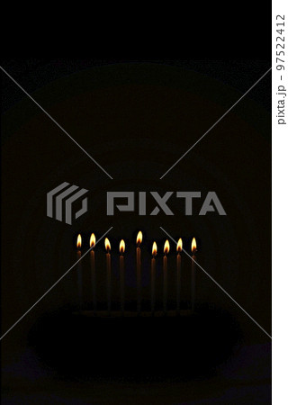 Religious image of Jewish holiday Hanukkah with candles of menorah on black background Religious image of Jewish holiday Hanukkah with candles of menorah on black background 97522412