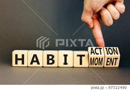 Habit action and moment symbol. Concept words Habit action Habit moment on wooden cubes. Businessman hand. Beautiful grey table grey background. Business habit action moment concept. Copy space. 97522490