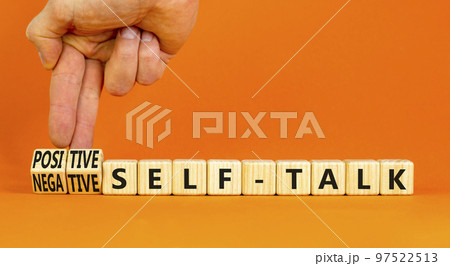 Positive or negative self-talk symbol. Concept words Positive self-talk and Negative self-talk on cubes. Beautiful orange background. Psychological positive or negative self-talk concept. Copy space. 97522513