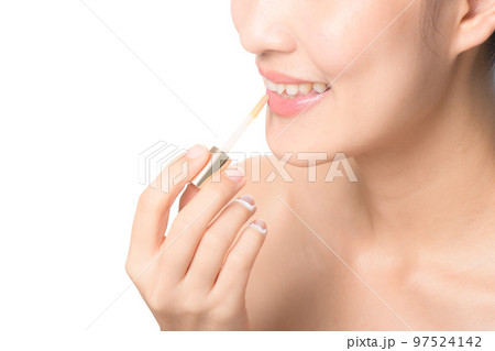 Beautiful portrait young asian woman looking mirror applying makeup lipstick at room. clipping path Beautiful portrait young asian woman looking mirror applying makeup lipstick at room. clipping path 97524142