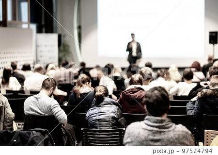 Speaker giving a talk in conference hall at business event. Audience at the conference hall. Business and Entrepreneurship concept. Focus on unrecognizable people in audience. Speaker giving a talk in conference hall at business event. Audience at the conference hall. Business and Entrepreneurship concept. Focus on unrecognizable people in audience. 97524794